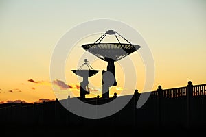 The silhouette of a radio telescope