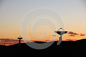 The silhouette of a radio telescope