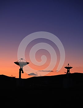 The silhouette of a radio telescope