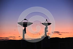 The silhouette of a radio telescope