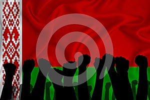 Silhouette of raised arms and clenched fists on the background of the flag of  Belarus. The concept of power,  conflict. With