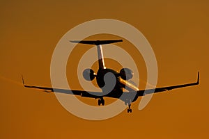 Silhouette of regional jet facing sun photo