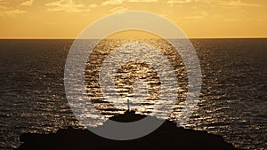 Silhouette of a religious Cross Crucifix against the sea