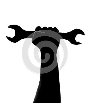 Silhouette of repairman hand with wrench