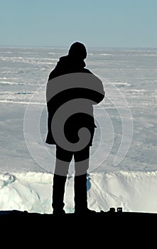 Silhouette of researcher in front of Antarctica