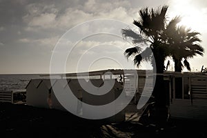 Silhouette of resort beach and guy running on tropical beach at sunset - Young boy enjoying time in summer vacation - Travel,