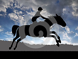 Silhouette of a rider on a running horse