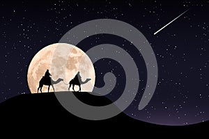 Silhouette of riders on their camels in the desert at night