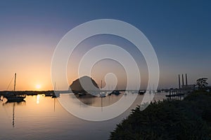 Silhouette of riding boats at sunset in Morro Bay, California, United States photo