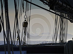 Silhouette of a rigging against foggy sea