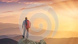 Silhouette of a rock climber at the mountain valley background.