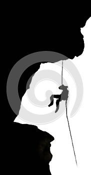 Silhouette of a rock climber on rappel photo