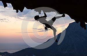 Silhouette of a rock climber at sunset