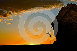 Silhouette of Rock Climber at Sunset