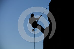 Silhouette rock climbing