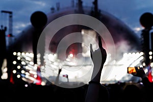 Silhouette of Rock and Roll hand sign against concert stage light