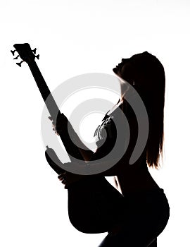 Silhouette of rock woman playing on electric guitar on a white background.