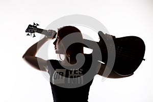Silhouette of rock woman playing on electric guitar on a white background.