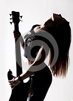 Silhouette of rock woman playing on electric guitar on a white background.