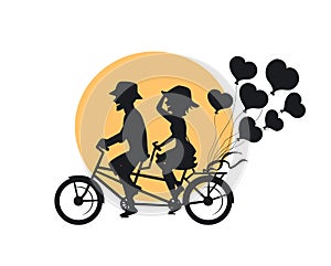 Silhouette of romantic cheerful couple riding tandem bike with heart shaped balloons