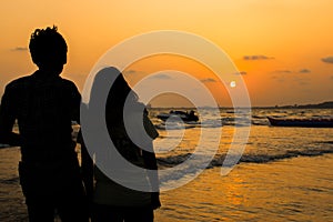 Silhouette of romantic couple on tropical beach