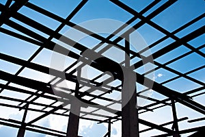 Silhouette Roof structure with steel on the concrete pillars and blue sky