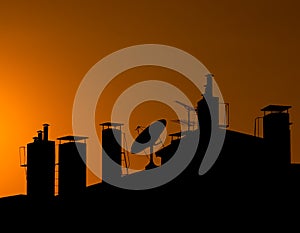 Silhouette of a Roof Top with Chimneys