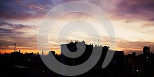 The silhouette of the roofs of the morning city