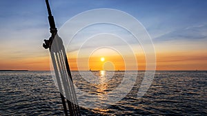 Pulley silhouette on a sailboat at sunset