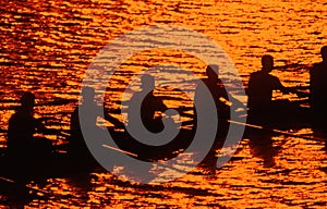 Silhouette of rowing crew at sunset photo