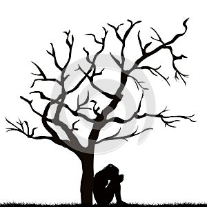 Silhouette of a sad woman under a leafless tree