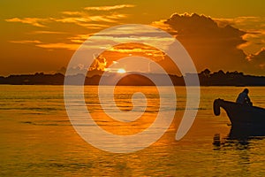 Silhouette of a sailboat on sea against sky during sunset in Shela Beach, Lamu Island, Kenya