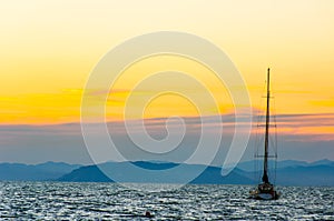 Silhouette of sailing boat at sunset