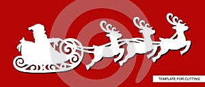 Silhouette of Santa Claus flying in a sleigh with reindeers.