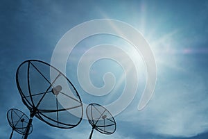 Silhouette, Satellite dish on blue sky with bright sun rays shining, communication technology network image background