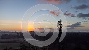 silhouette satellite dish cell tower telecom network at sunset communication technology network