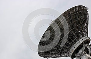 The silhouette of a satellite dish or radio antenna. Space observatory or air defense radar