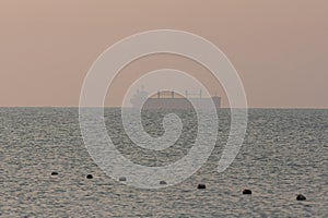 Silhouette of a sea tanker in the sea at dawn. Odesa. Ukraine