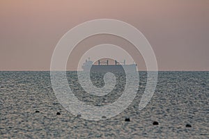 Silhouette of a sea tanker in the sea at dawn. Odesa. Ukraine