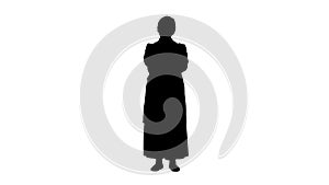 Silhouette Serious senior physician woman standing with hands crossed.