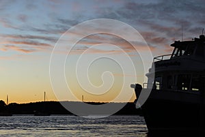 Silhouette of a ship in Batemans Bay at sunset. Australia.