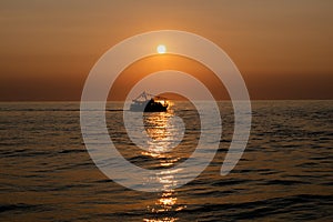 The silhouette of a ship sailing on the sea
