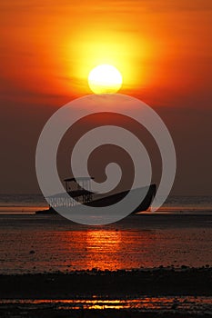 Silhouette of shipwreck and beautiful sunset in Phuket, Thailand