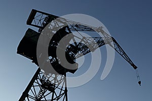 Silhouette of shipyard`s tall crane.