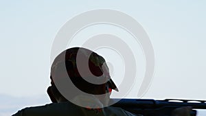 Silhouette of a shooter man skeet shooting in a sports competition