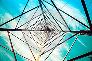 Silhouette shot of electricity pylons with cloudy sky