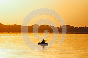 Silhouette shot of male fishing in the river in Brcko district, Bosnia and Herzegovina