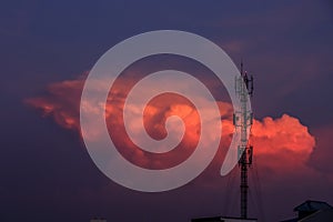 Silhouette signal antenna tower at sunset sky