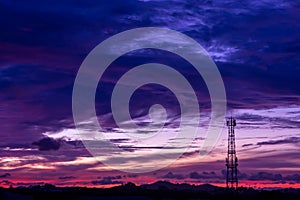 Silhouette signal antenna tower at sunset sky