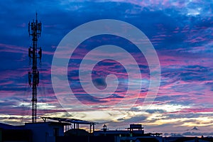 Silhouette signal antenna tower at sunset sky